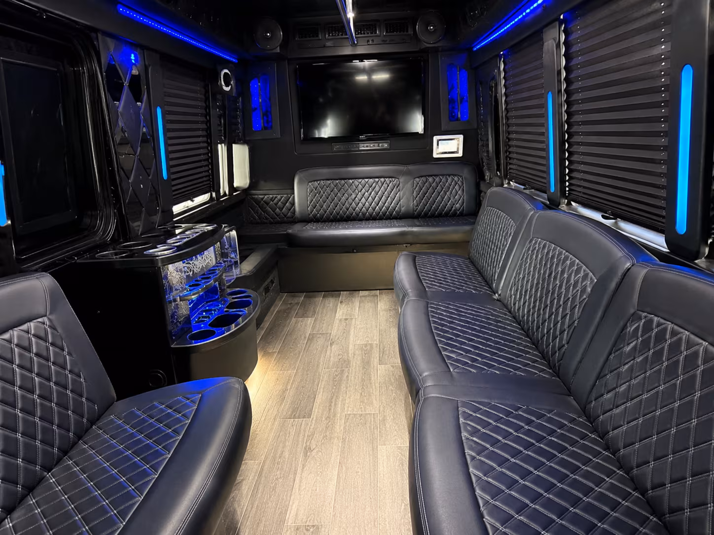 Friends laughing during a party bus celebration in Aurora